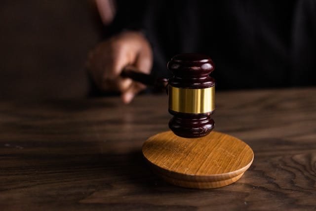 a court room judge offers legal protection to autistic and disabled workers who are covered by the equality act 2010 in the uk and americans with disabilities act 1990 in the usa