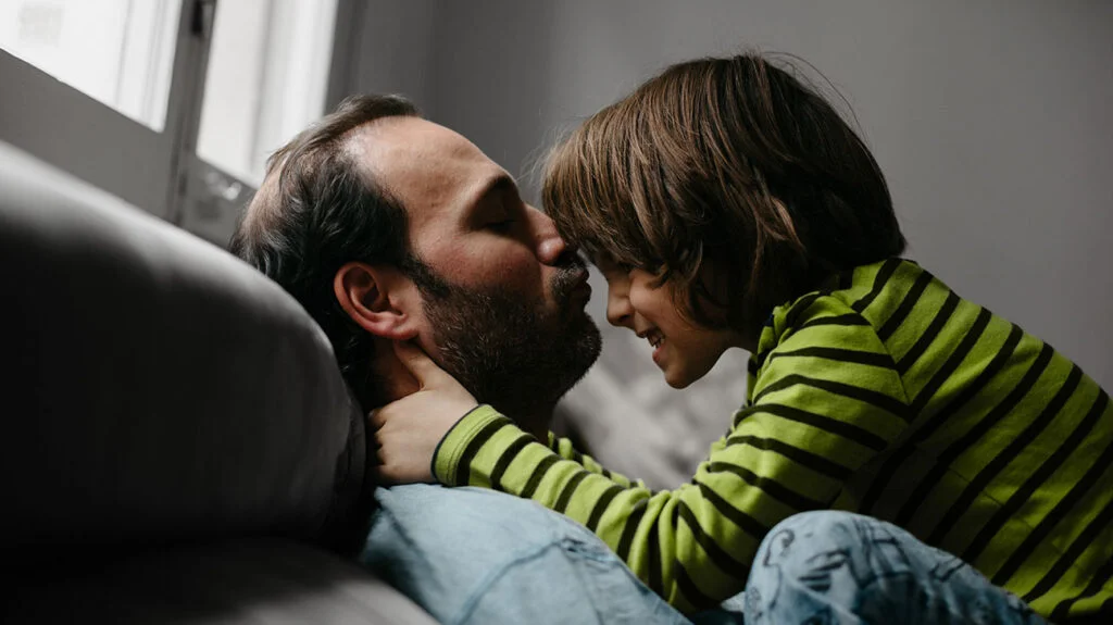 a father shows empathy and love to his autistic son