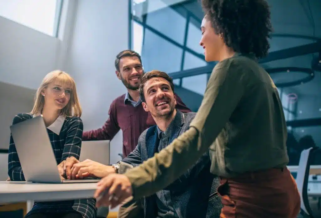 a female leader demonstrates positive behaviors in front of her team